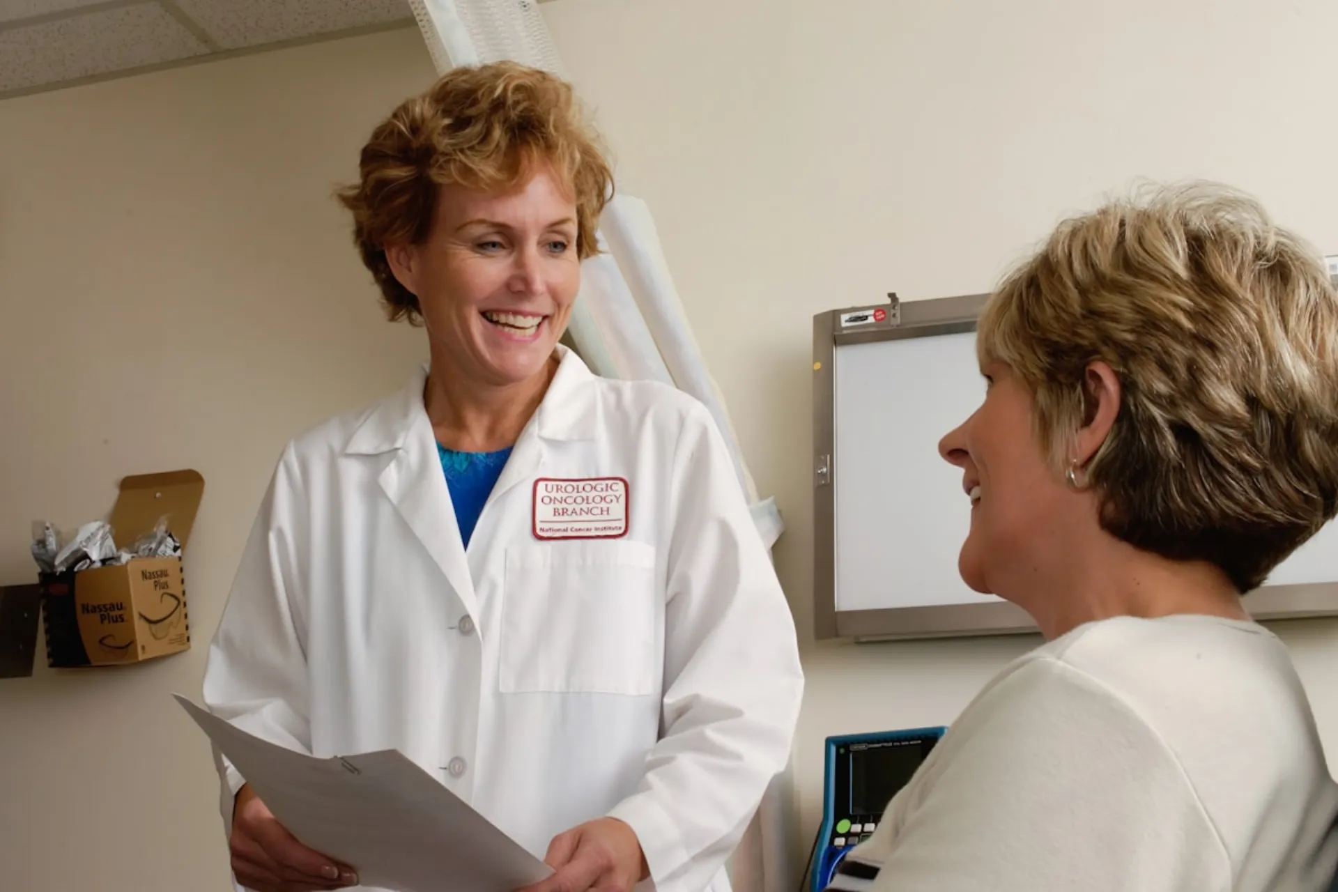 A clinician talking with a staff member at the front desk